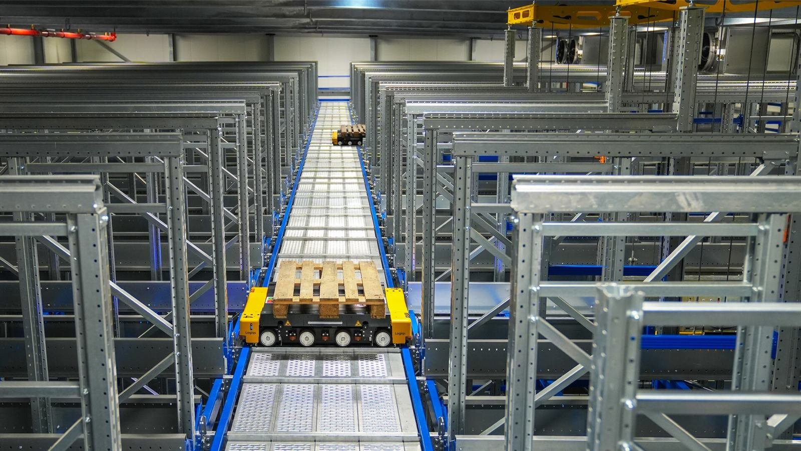 Automated storage and retrieval system with pallet shuttles running between high racking